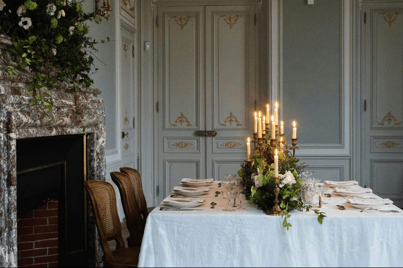 A candlelit table in a grand, elegant venue