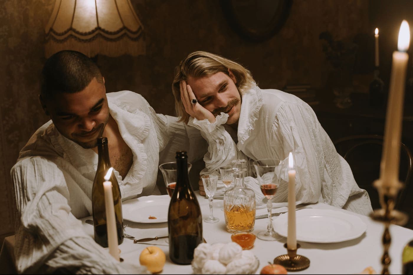 A couple sharing a candlelit dinner