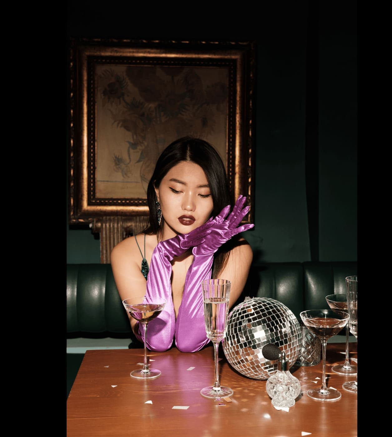 A glamorously styled wedding guest holding a coupe