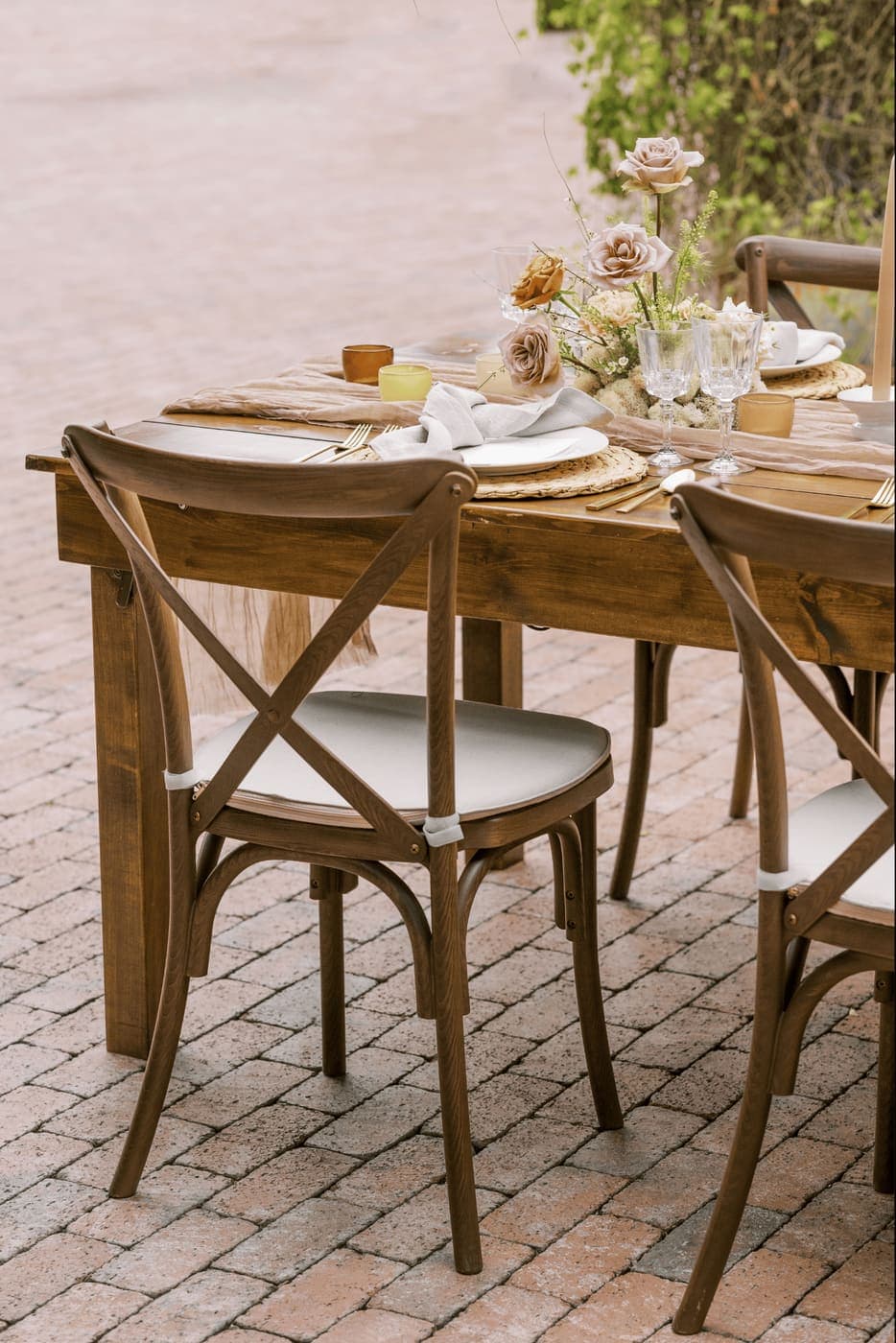 Wooden crossback chairs at a farmhouse-style wedding table